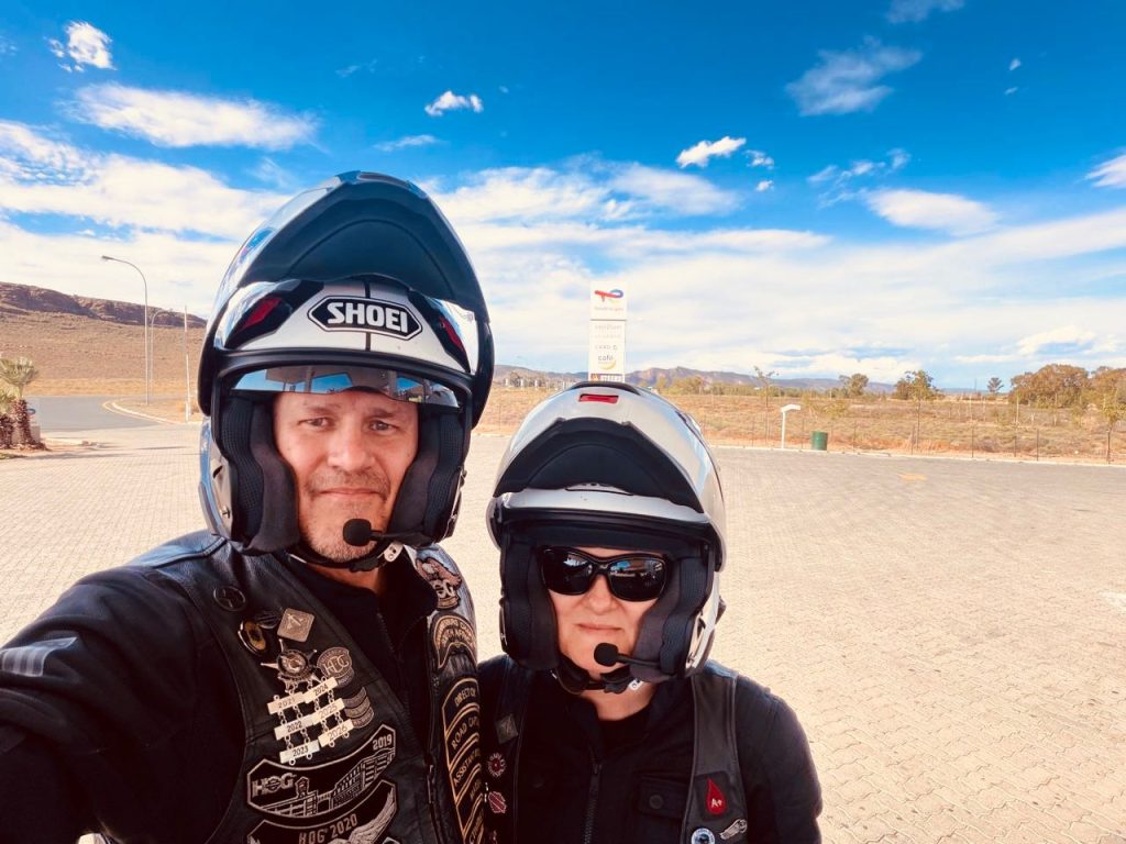 Ryan and Jacqui Bosch in helmets at a Karoo filling station