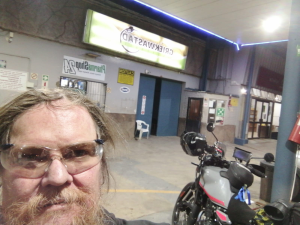 Dominic Spreemann in riding glasses at the Griekwastad filling station with his Royal Enfield Himalayan