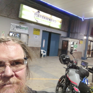 Dominic Spreemann in riding glasses at the Griekwastad filling station with his Royal Enfield Himalayan