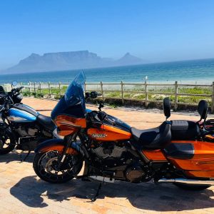Two Harley-Davidsons parked at Table View with Table Mountain across the bay