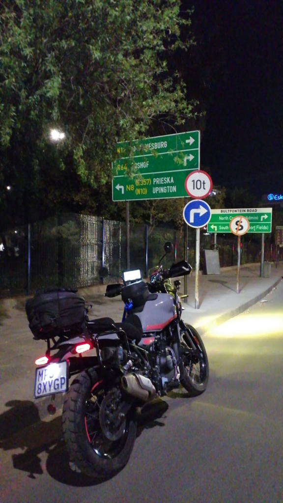 Royal Enfield Himalayan at night beside the N8 sign in Bloemfontein